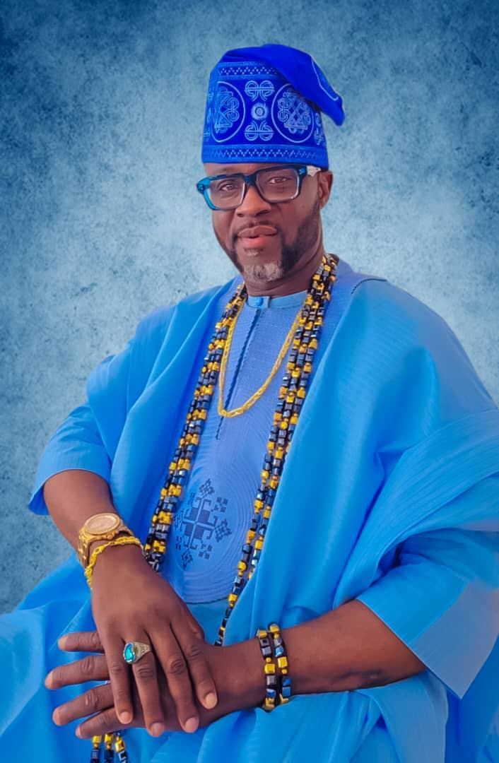 Adekunle Moshood in royal blue Agbada with Fila